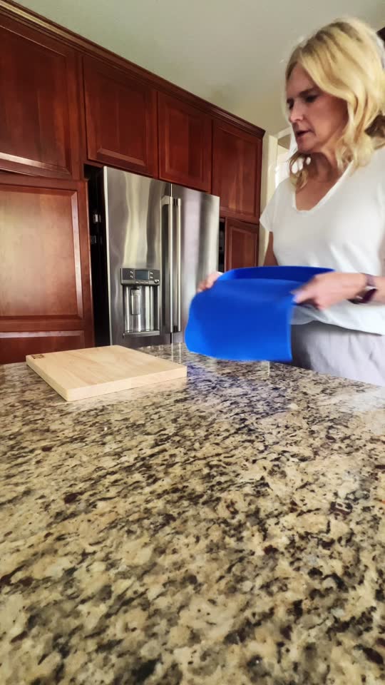 Home cook slicing cucumbers on a board over the ROO mat